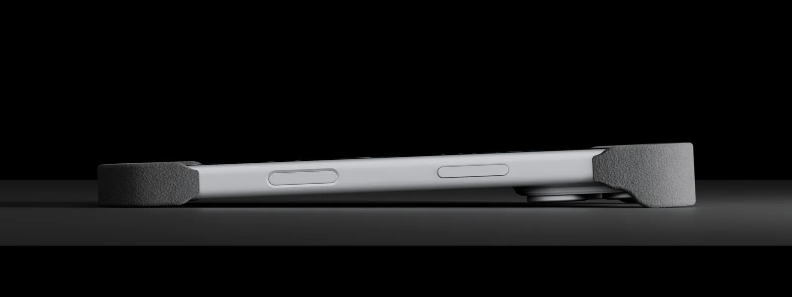 iPhone 17 Pro with Phone Shell lying on its back: only the printed caps touch, the camera floats clear of the table